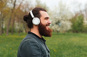 Man smiling while walking through park