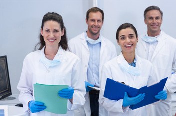 Dental team member showing a tablet screen to a patient