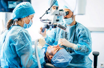 team carefully performing dental implant surgery