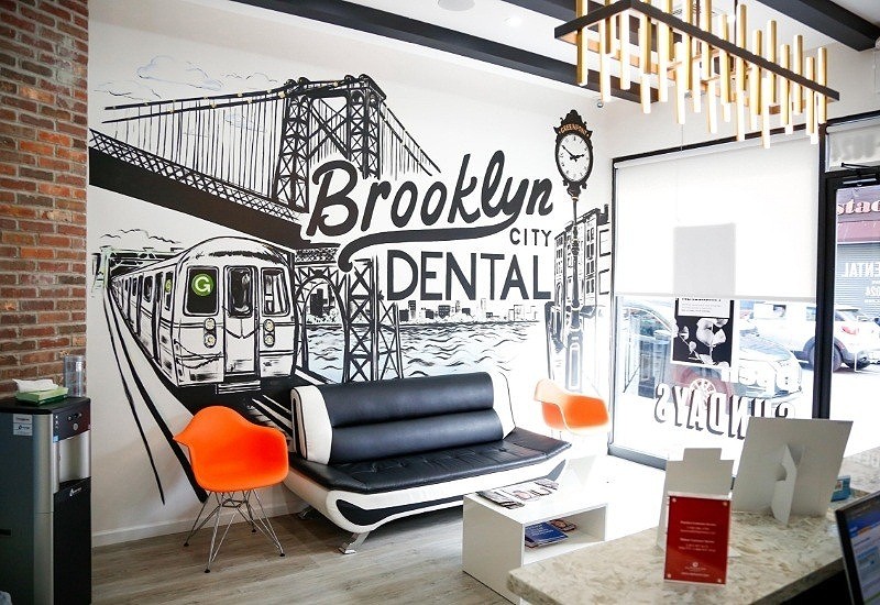 Mural with subway train and bridge on wall of waiting room in Brooklyn dental office