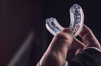 Person holding a mouthguard