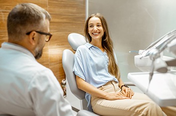 Young woman speaking to dentist about treatment options